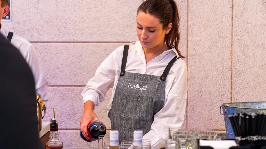Uniformed wait staff setting up a catering spread at a Sydney memorial venue